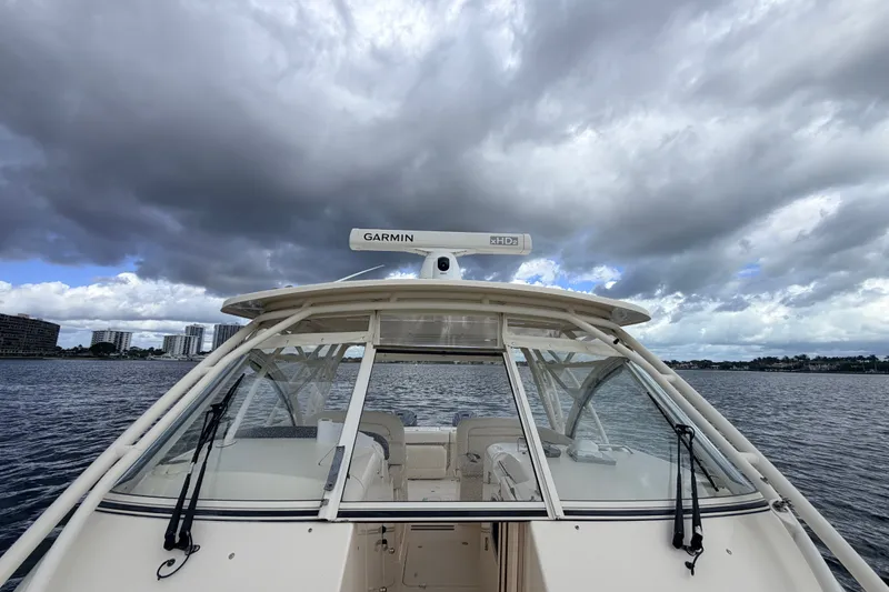 Slide: The Image of 2021 Grady-White Freedom 335 boat on water under cloudy sky. - 10