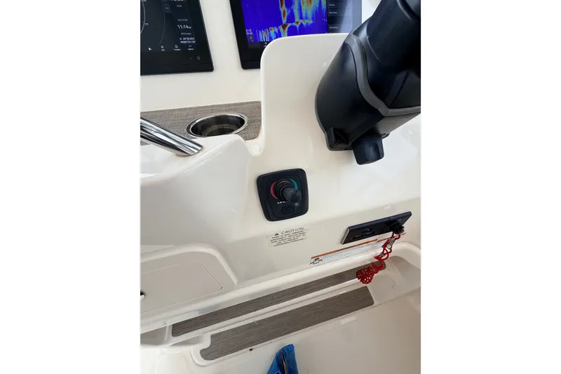 Slide: The Image of Control panel of 2021 Grady-White Freedom 335 boat with steering and display screens. - 19