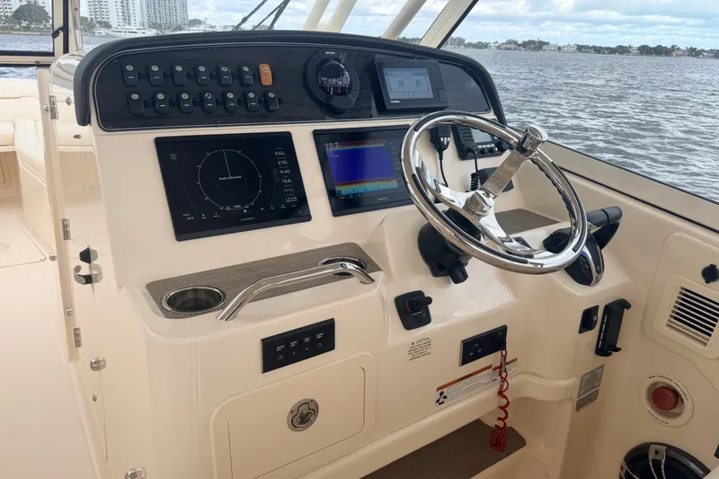 Slide: The Image of Helm of 2021 Grady-White Freedom 335 boat with modern navigation controls. - 13