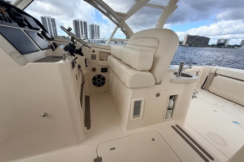 Slide: The Image of 2021 Grady-White Freedom 335 boat interior with helm, seating, and water view. - 20