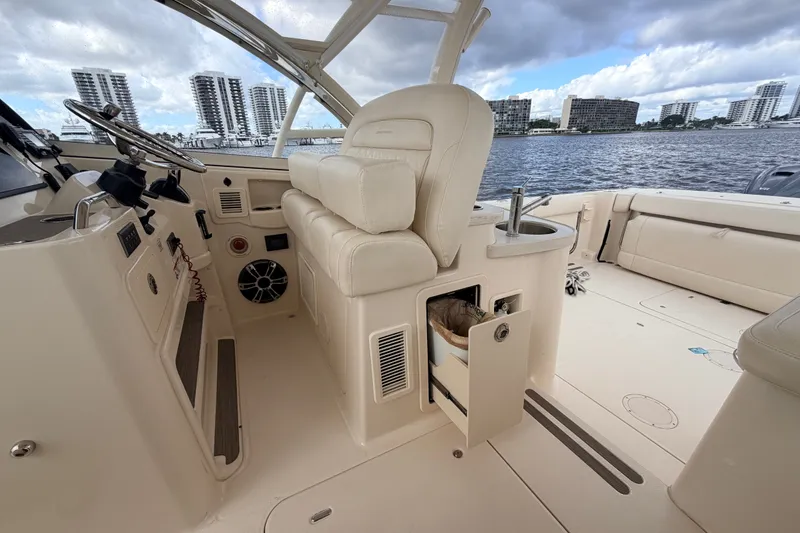 Slide: The Image of Interior of 2021 Grady-White Freedom 335 boat with seating and helm, dockside view. - 21