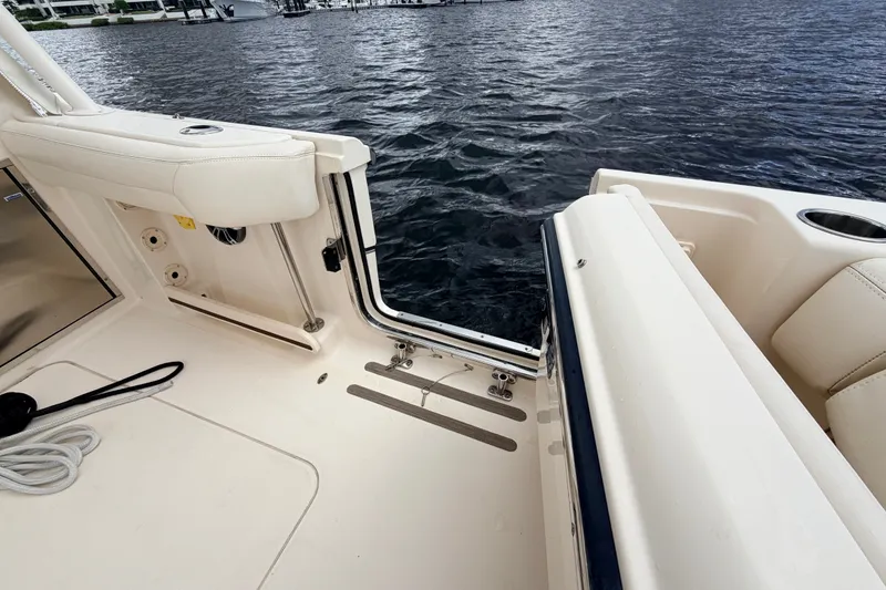 Slide: The Image of 2021 Grady-White Freedom 335 boat interior with open side door, docked on water. - 43