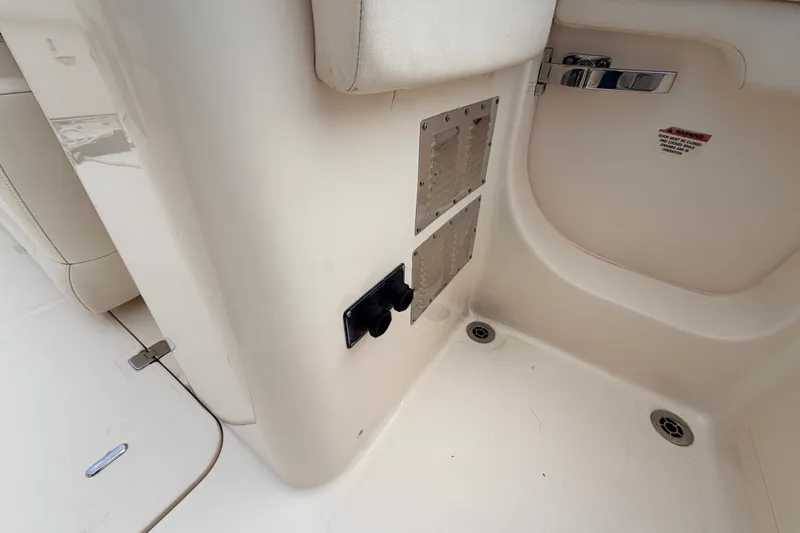 Slide: The Image of Interior view of a 2021 Grady-White Freedom 335 boat, featuring control panels and seating. - 65