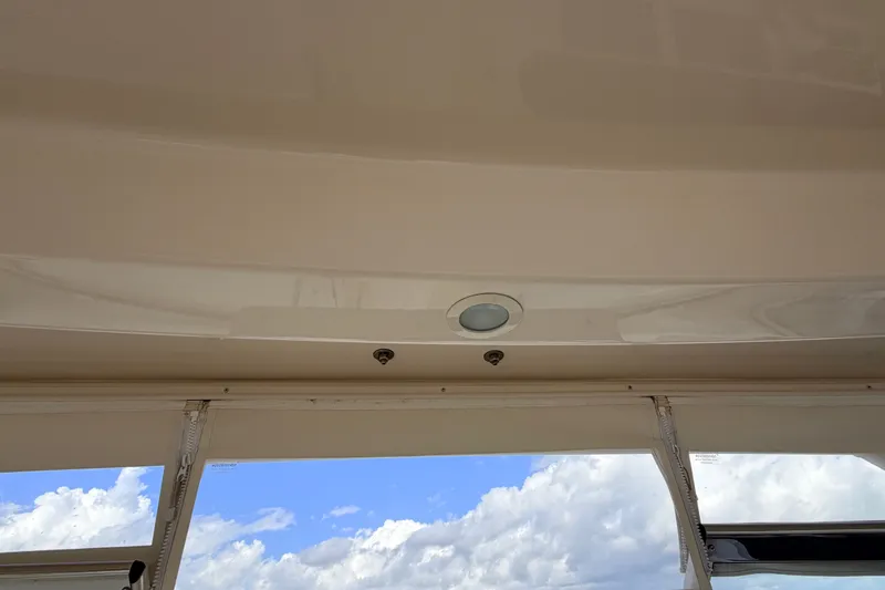 Slide: The Image of 2021 Grady-White Freedom 335 boat interior ceiling with lighting, under a partly cloudy sky. - 74