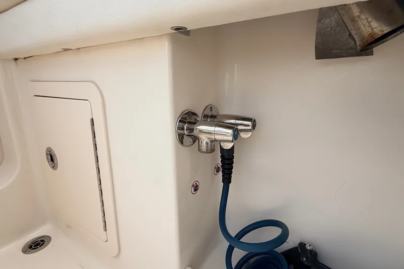 Slide: The Image of 2021 Grady-White Freedom 335 boat deck with hose and storage compartment. - 77