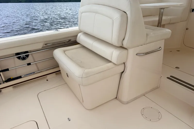 Slide: The Image of Interior of 2021 Grady-White Freedom 335 boat with white seating and lake view. - 46