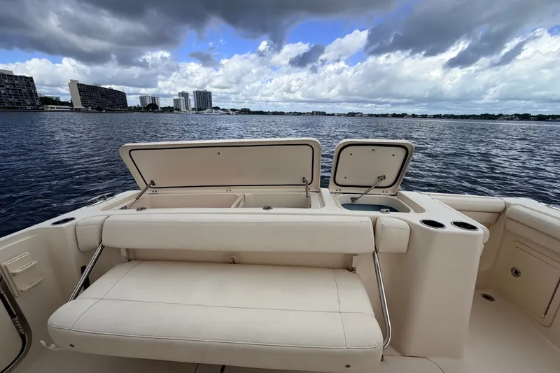 Slide: The Image of 2021 Grady-White Freedom 335 boat interior with open storage, on a calm water backdrop. - 40