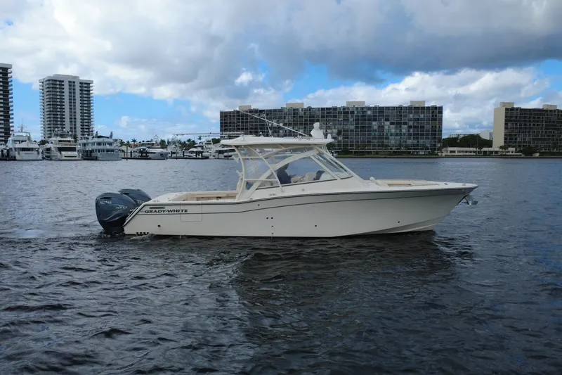 The Image of 2021 Grady-White Freedom 335 boat on water with city skyline background. - 0