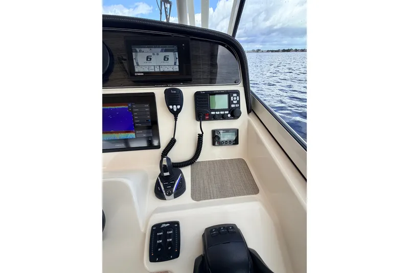 Slide: The Image of Control panel of 2021 Grady-White Freedom 335 boat with navigation and communication equipment. - 59