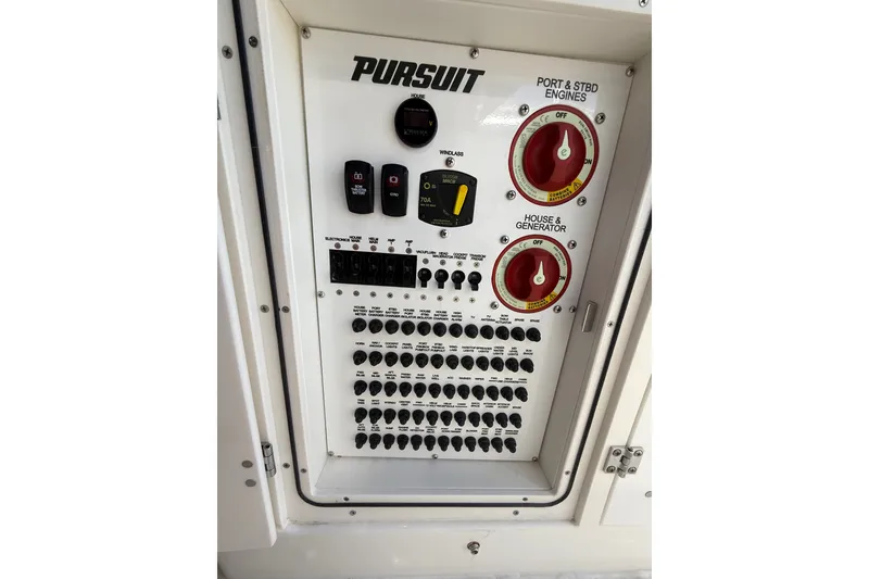Slide: The Image of Control panel of 2025 Pursuit S 328 Sport boat with switches and dials. - 17