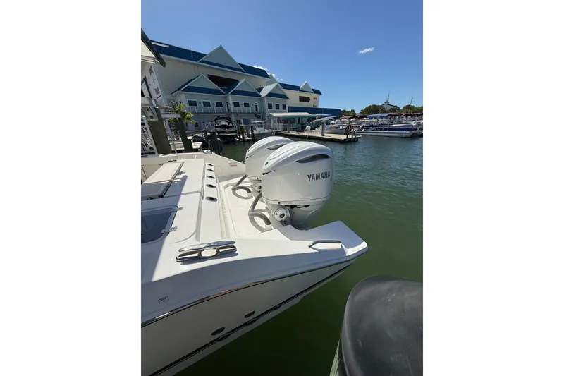 Slide: The Image of 2025 Pursuit S 328 Sport boat with Yamaha engines docked at marina. - 13