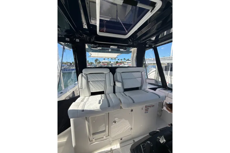 Slide: The Image of 2025 Pursuit S 328 Sport boat interior with luxurious seating and panoramic windows. - 10