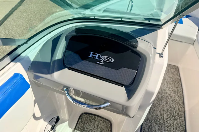Slide: The Image of 2017 Chaparral 19 Sport H2O boat interior with glove compartment and blue accents. - 55