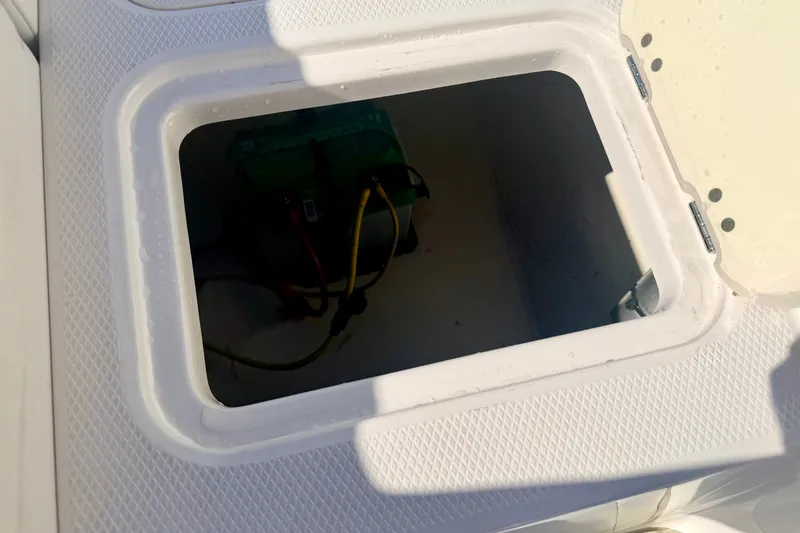 Slide: The Image of Battery compartment of a 2017 Chaparral 19 Sport H2O boat. - 33