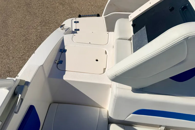 Slide: The Image of 2017 Chaparral 19 Sport H2O boat interior with white seating and storage compartments. - 29