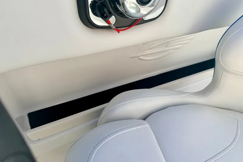 Slide: The Image of Interior of 2017 Chaparral 19 Sport H2O boat with white seating and speaker detail. - 52
