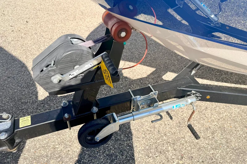 Slide: The Image of Trailer hitch and winch of a 2017 Chaparral 19 Sport H2O boat on pavement. - 74