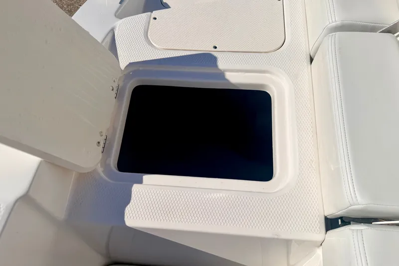 Slide: The Image of Open storage compartment on 2017 Chaparral 19 Sport H2O boat deck. - 31