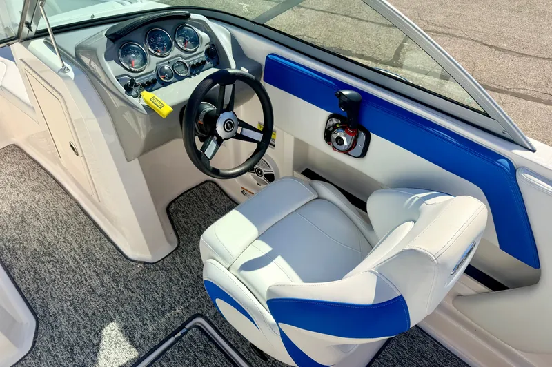 Slide: The Image of 2017 Chaparral 19 Sport H2O boat interior with steering wheel and dashboard controls. - 44