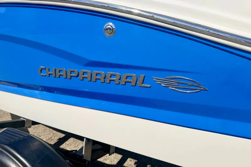 Slide: The Image of 2017 Chaparral 19 Sport H2O boat with blue and white exterior detailing. - 8
