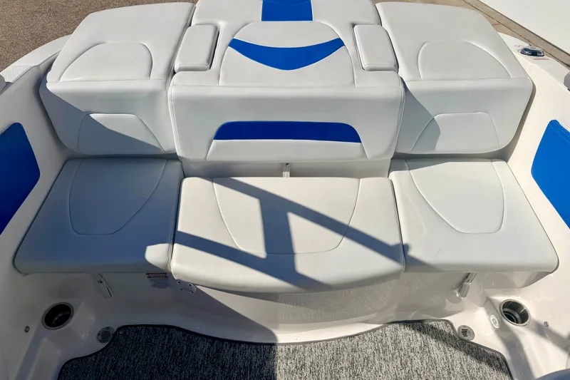 Slide: The Image of 2017 Chaparral 19 Sport H2O boat interior with white and blue cushioned seating. - 28