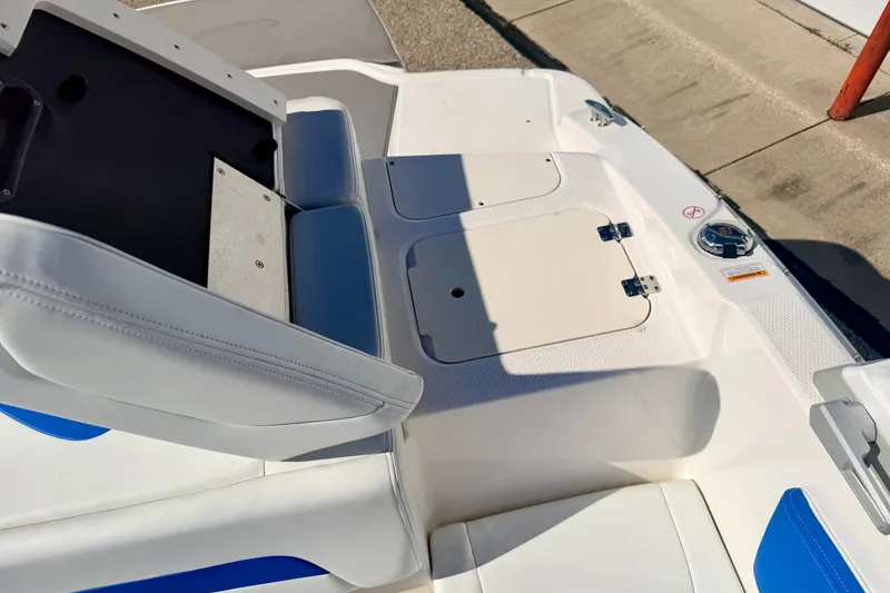 Slide: The Image of 2017 Chaparral 19 Sport H2O boat interior with seating and storage compartments. - 32