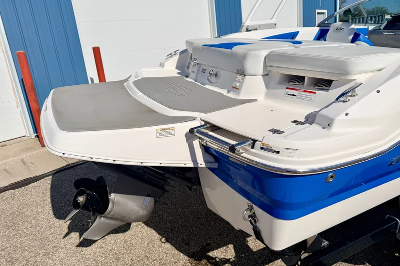 Slide: The Image of 2017 Chaparral 19 Sport H2O boat, blue and white, rear view with swim platform. - 24