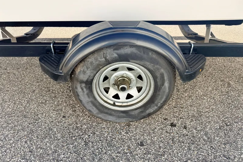 Slide: The Image of Trailer wheel of a 2017 Chaparral 19 Sport H2O on asphalt. - 77