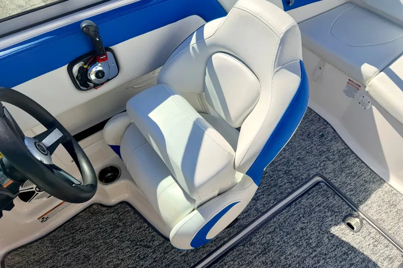 Slide: The Image of 2017 Chaparral 19 Sport H2O boat interior with steering wheel and cushioned seat. - 51