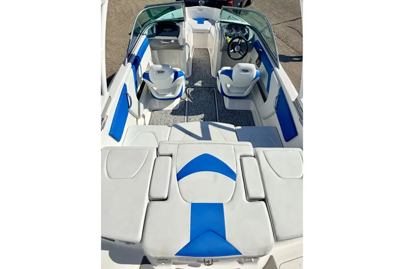 Slide: The Image of 2017 Chaparral 19 Sport H2O boat interior with blue and white seating and steering console. - 73