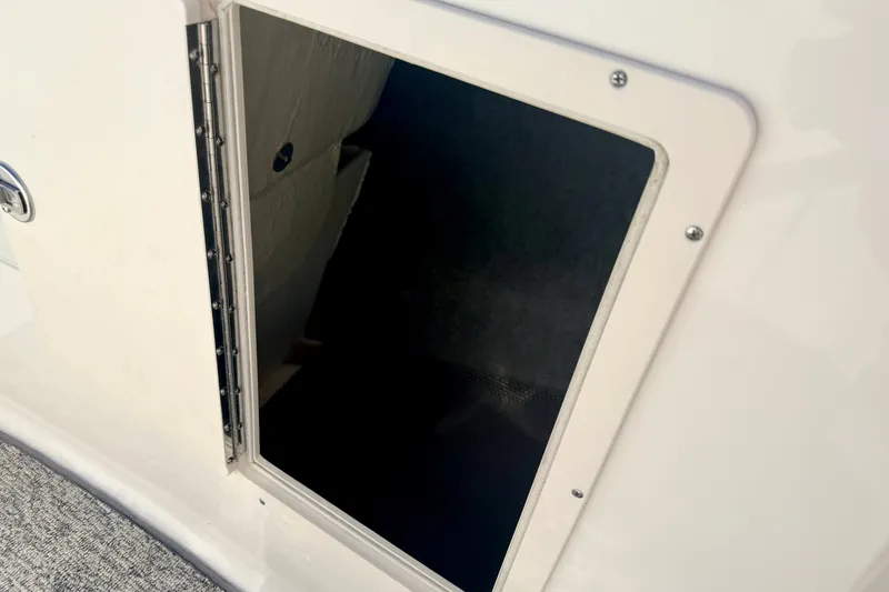 Slide: The Image of Open storage compartment on 2017 Chaparral 19 Sport H2O boat. - 67