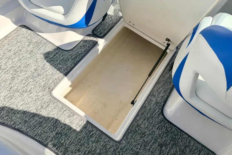 Slide: The Image of 2017 Chaparral 19 Sport H2O boat interior storage compartment with blue and white seating. - 59