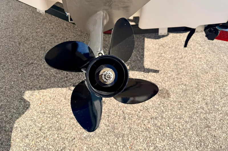 Slide: The Image of Propeller of 2017 Chaparral 19 Sport H2O boat on pavement background. - 20