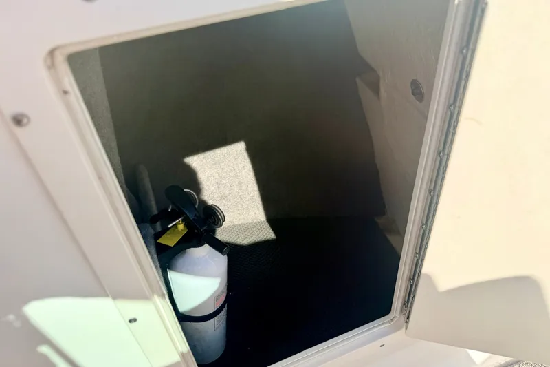 Slide: The Image of Storage compartment with fire extinguisher in 2017 Chaparral 19 Sport H2O boat. - 69