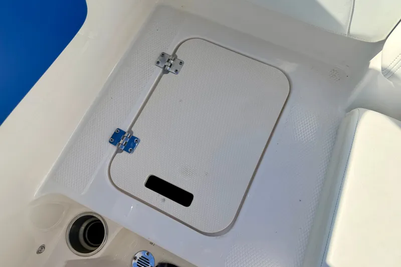 Slide: The Image of 2017 Chaparral 19 Sport H2O boat floor hatch with cup holder and speaker. - 37