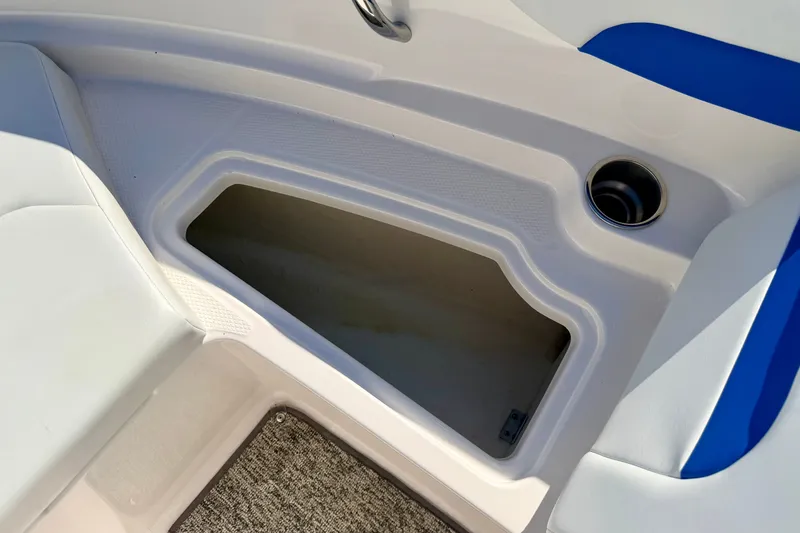 Slide: The Image of 2017 Chaparral 19 Sport H2O boat storage compartment with cup holder. - 65