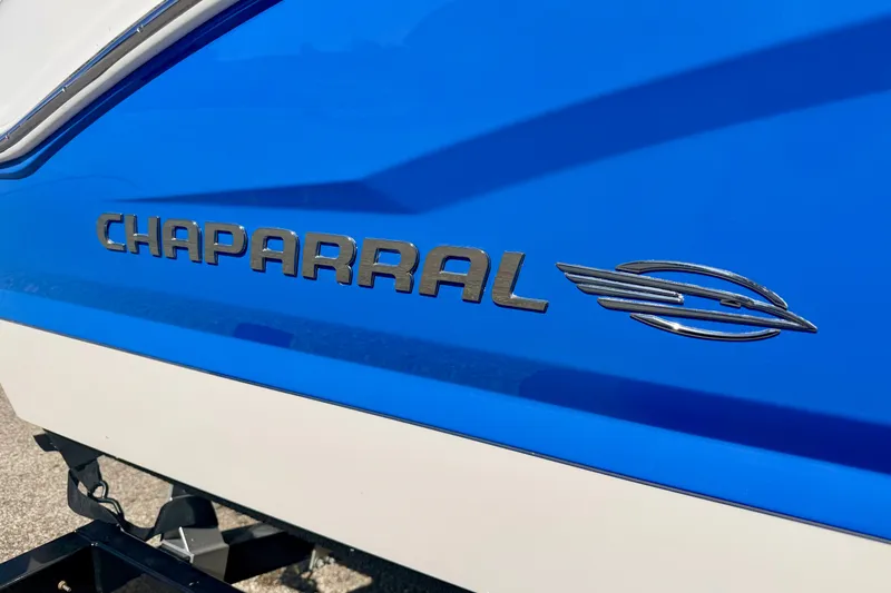 Slide: The Image of 2017 Chaparral 19 Sport H2O boat logo on blue and white hull. - 14