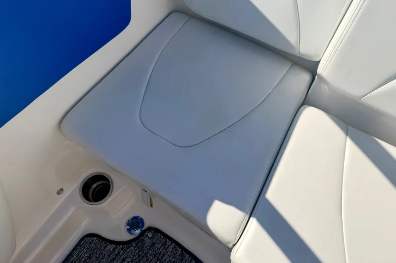 Slide: The Image of 2017 Chaparral 19 Sport H2O boat seat with white upholstery and blue accent. - 36