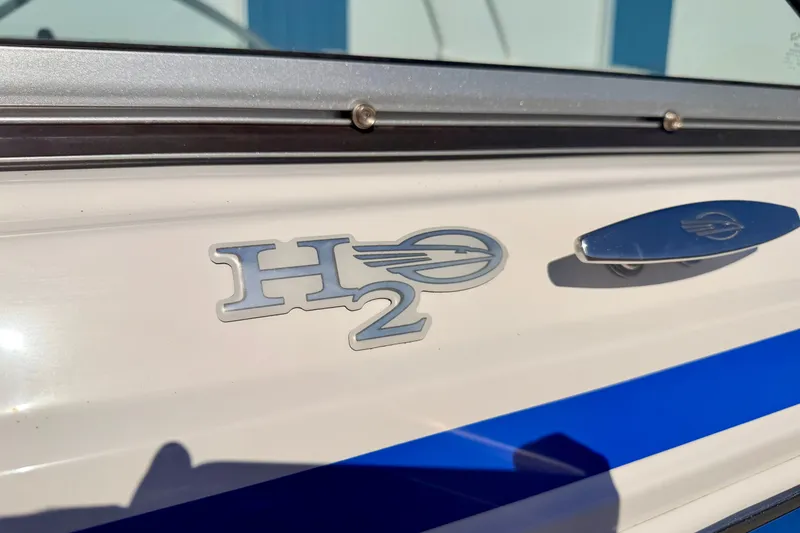 Slide: The Image of 2017 Chaparral 19 Sport H2O boat emblem with blue stripe detail. - 10