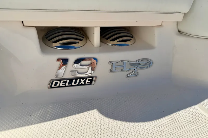 Slide: The Image of 2017 Chaparral 19 Sport H2O Deluxe boat emblem on white surface. - 23