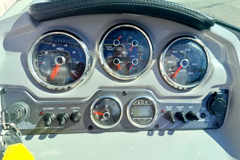 Slide: The Image of Dashboard of a 2017 Chaparral 19 Sport H2O boat with gauges and controls. - 46