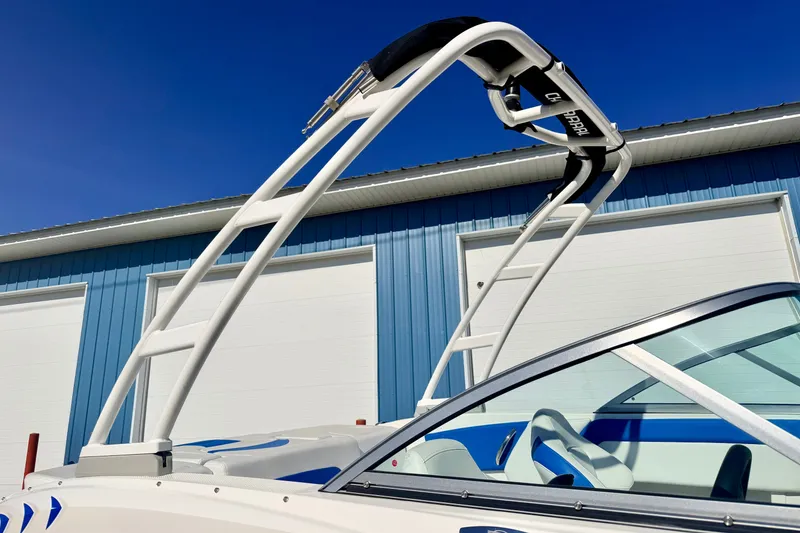 Slide: The Image of 2017 Chaparral 19 Sport H2O boat with wakeboard tower against blue sky. - 19