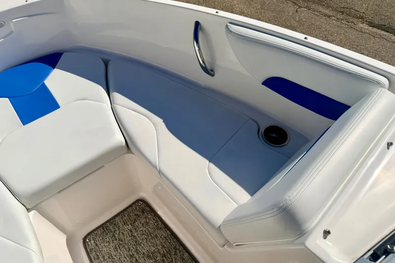 Slide: The Image of 2017 Chaparral 19 Sport H2O boat interior with white and blue seating, cup holder. - 64