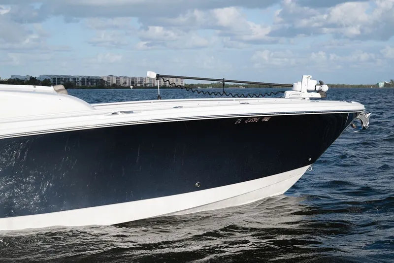Slide: The Image of 2020 Edgewater 370CC boat cruising on open water under a cloudy sky. - 11