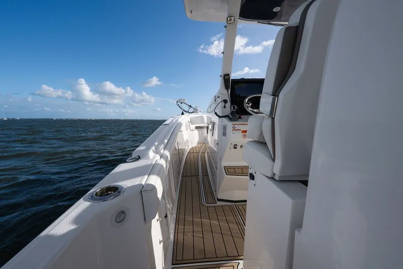 Slide: The Image of 2020 Edgewater 370CC boat interior with ocean view, featuring sleek seating and modern controls. - 21