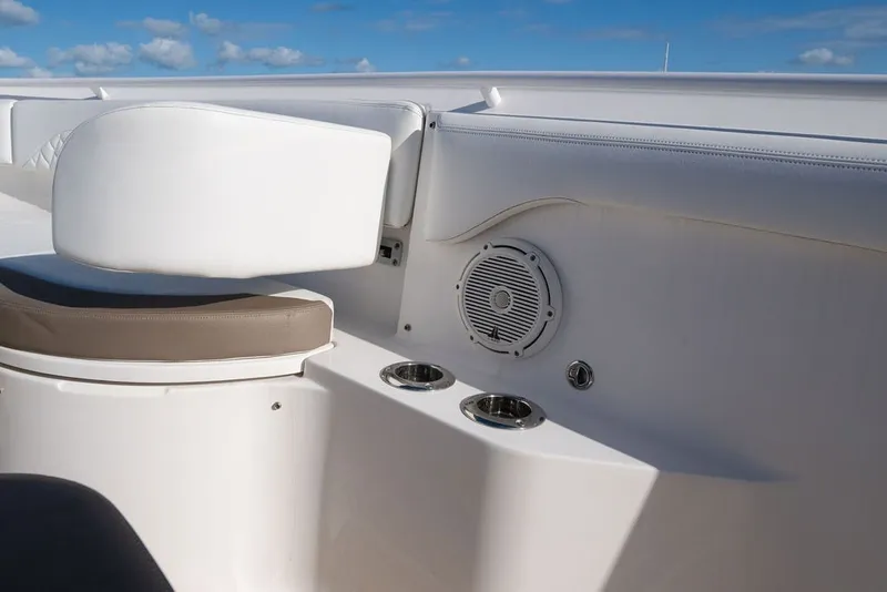 Slide: The Image of 2020 Edgewater 370CC boat interior with seating, speaker, and cup holders. - 61
