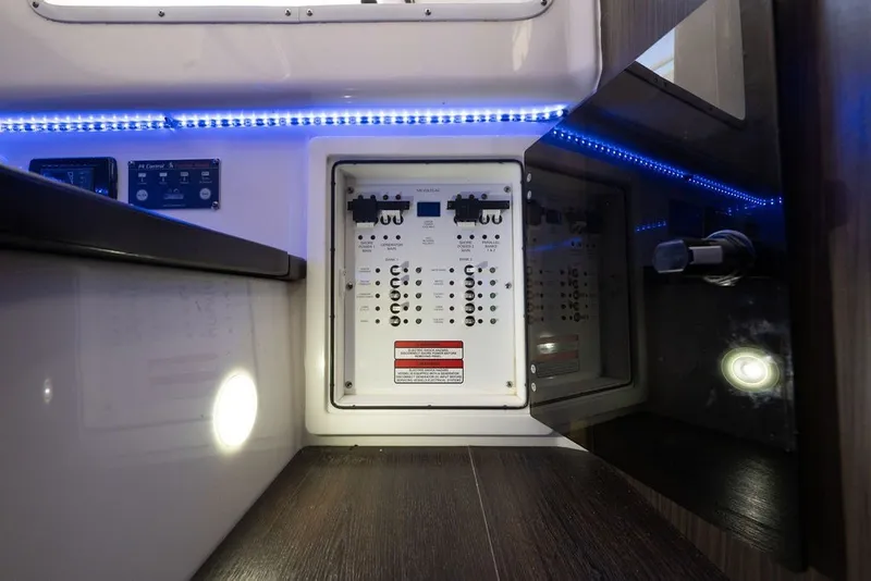 Slide: The Image of Electrical panel inside 2020 Edgewater 370CC boat, featuring LED lighting and control switches. - 38