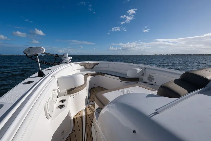Slide: The Image of 2020 Edgewater 370CC boat interior with ocean view, featuring seating and clear blue sky. - 64