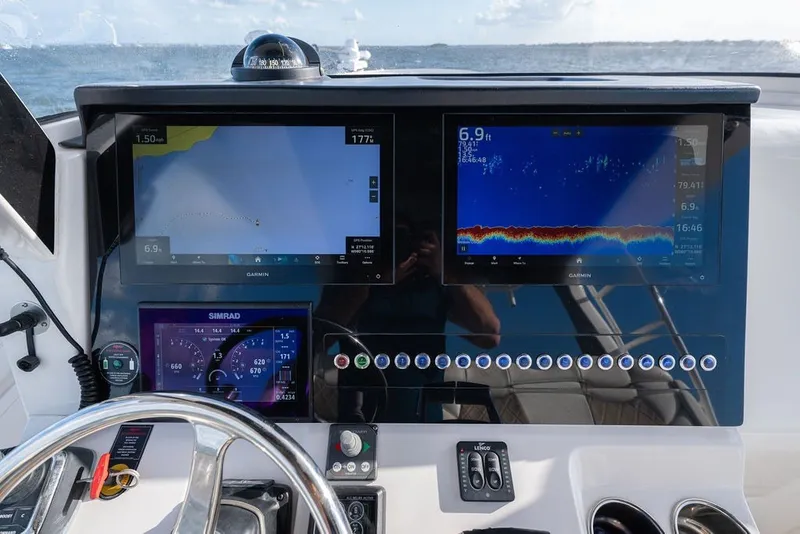 Slide: The Image of Edgewater 370CC 2020 boat dashboard with navigation and sonar displays at sea. - 32