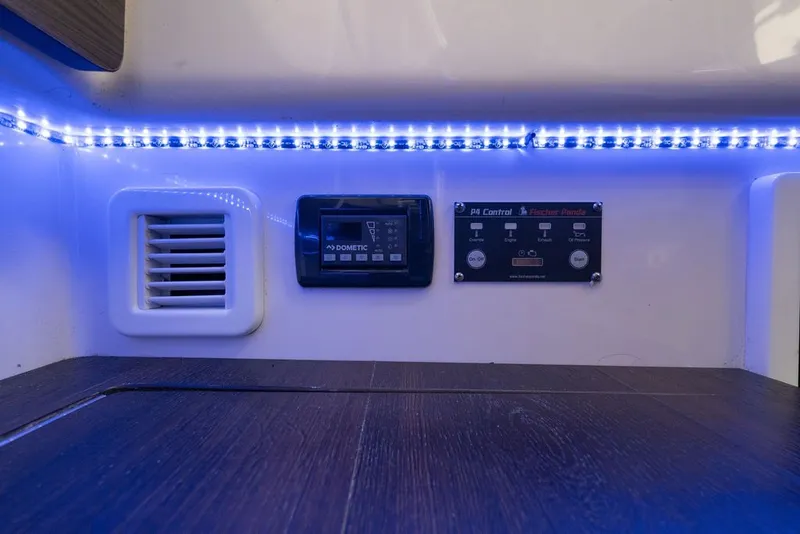 Slide: The Image of Control panel and vent with blue LED lighting on 2020 Edgewater 370CC boat interior. - 39